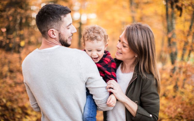 Le Polaire Eco-Responsable : Comment Choisir des Vêtements Respectueux de l'Environnement Trois personne papa, maman et leur enfant dans la foret en automne, chacun porte une polaire.